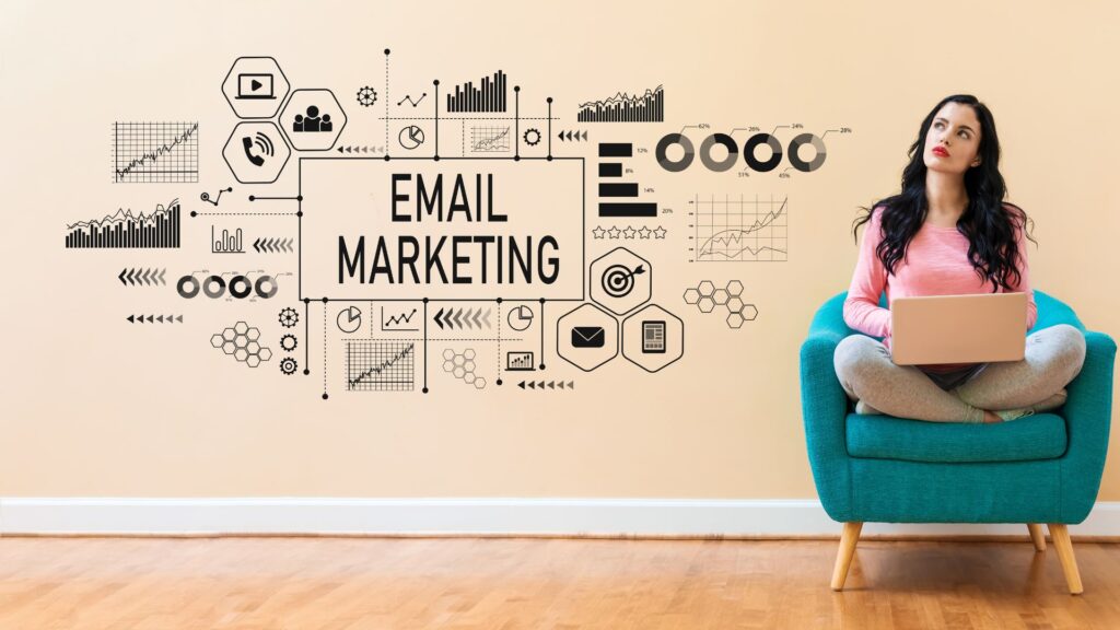 A woman in a chair next to an illustration of the concept of email marketing.